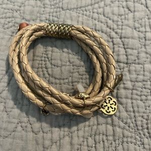 Tan braided layer bracelet with multiple dangling charms